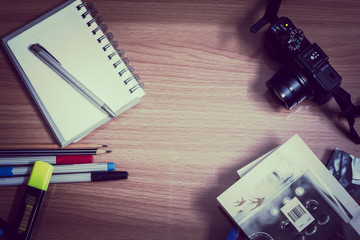 workplace with camera,pen and notepad,diary
workplace with camera,pen and notepad,diary on a table with colour.
