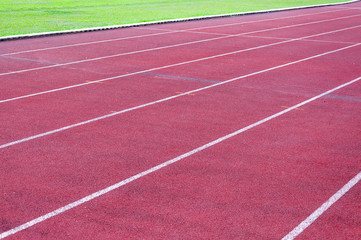 Fototapeta premium running track and green grass,Direct athletics Running track at Sport Stadium