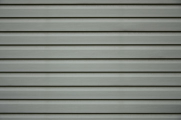 Siding, plastic panels texture closeup in the daytime outdoors