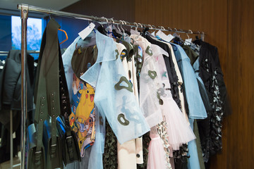 many designer clothes prepared for hanging on display trempel