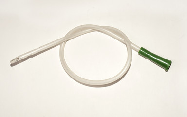 an intermittent transparent catheter isolated over a white backg