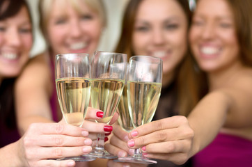Young ladies toasting with flutes of champagne
