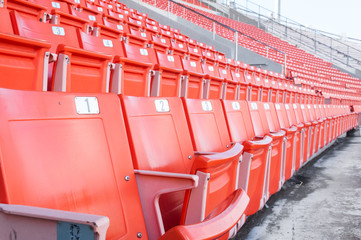 Empty orange seats at stadium,Rows of seat on a soccer stadium