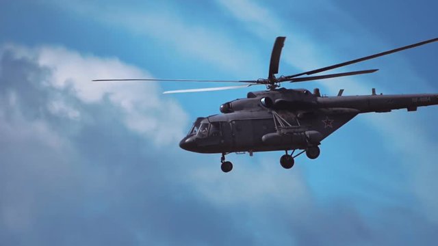 Multi-purpose helicopter Mi-8 flying on a background of blue sky and clouds. Includes audio. Contains audio