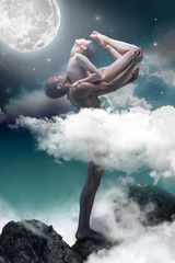 Couple of ballet dancers posing over gray fantasy background