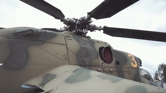Military attack helicopter Mi-24 standing on the airport. Center of helicopter Mi-24 rotor, place the blade mount