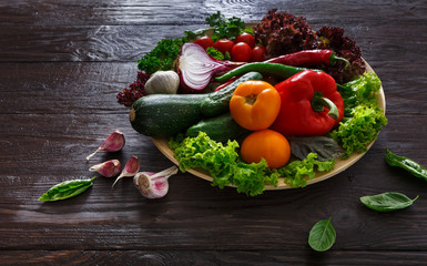 Plenty of fresh vegetables on wooden background with copy space
