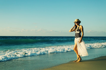 Fototapeta na wymiar Beautifull 40 years old woman walking on the beach