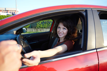 young woman driving a new car