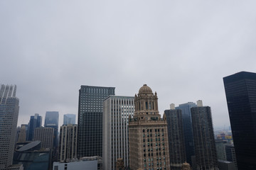 Buildings from the Chicago against foggy and cloudy sky