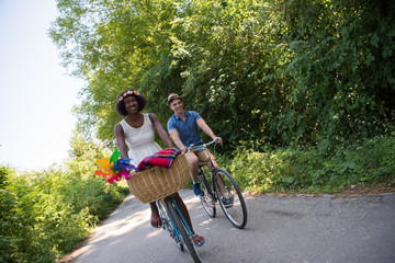 Obraz premium Young multiethnic couple having a bike ride in nature