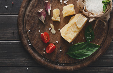 Cheese delikatessen closeup on rustic wood, brie and parmesan