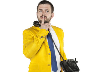 businessman does gesture of silence, talking on the phone