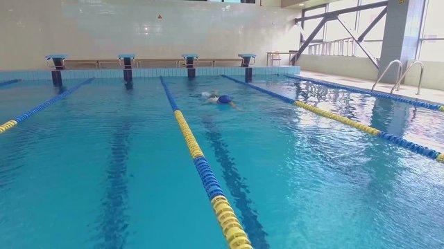 Professional woman swimmer training in swimming pool