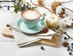 Pumpkin spice latte. Coffee cup on white wood background