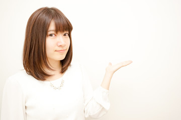 Young Japanese woman pointing something with smile
