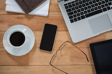 Laptop, digital tablet, mobile phone and organizer on desk
