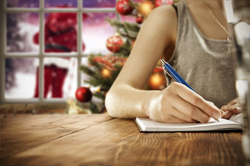 woman hand writing xmas letter 