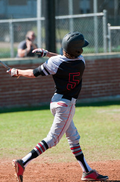 Teenage baseball player at bat