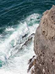 Waves breaking on rocky coast.