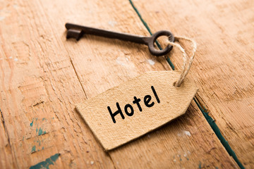 hotel key with tag on the wooden background
