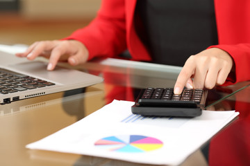 Businesswoman accounting with calculator and laptop