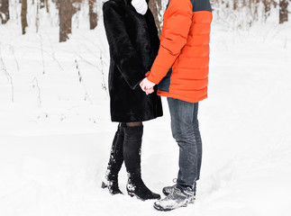 Young couple in love holding hands outdoor in winter