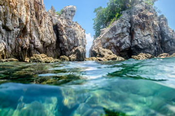 Cliff rock strait on emerald sea