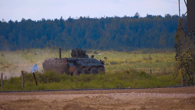 Btr-82a moving on the range on military exercises and firing a machine gun