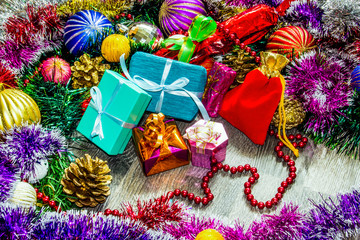 Fototapeta na wymiar New year picture. Gifts boxes, Christmas decorations, tinsel and beads