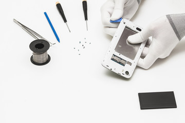 technician repairing broken mobile phone