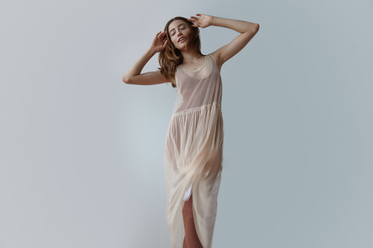 beauty woman in transparent light dress of ballerina dancing wit