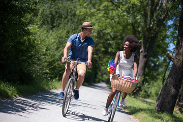 Young multiethnic couple having a bike ride in nature