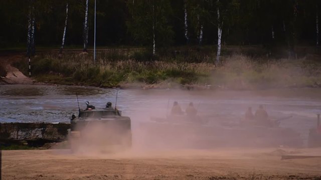 Several BMP moving to the river to cross the river by swimming. Includes audio. Contains audio