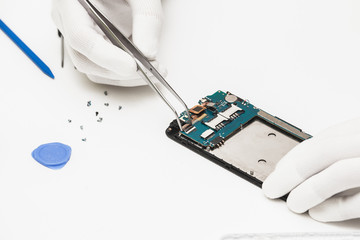 technician repairing broken mobile phone