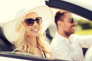 happy man and woman driving in cabriolet car