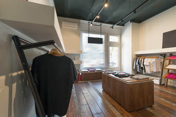 Interior of modern urban fashion clothes t-shirt store