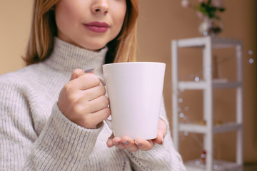 Woman hands holding hot cup of coffee or tea.