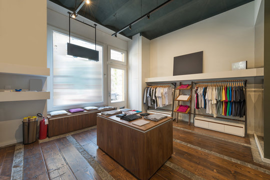 Interior of modern urban fashion clothes t-shirt store