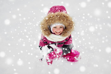 f happy little child or girl with snow in winter