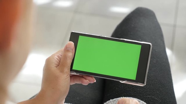 Display of mobile phone with green screen in blond female hands 4K 2160p 30fps UltraHD footage - Blonde woman holding chroma key greenscreen tablet 3840X2160 UHD video