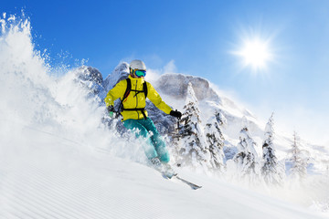 Skier on piste running downhill - obrazy, fototapety, plakaty