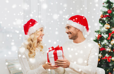 happy couple at home with christmas gift box