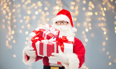 man in costume of santa claus with gift boxes