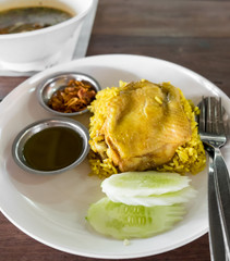 Rice curried chicken biryani with sauce sweet and sour and fried onion