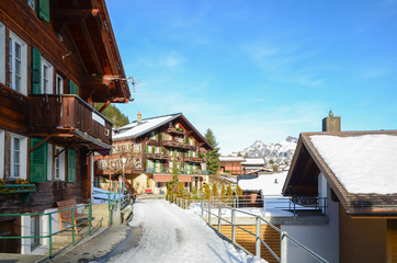 Traditional Swiss House and Alps mountains on background