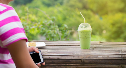 Man shooting food and beverage photo in nature with smartphone