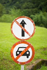 Olf prohibited sign saying do not go straight and do not car allow in green grass nature