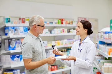 Poster pharmacist and senior man buying drug at pharmacy © Syda Productions