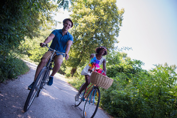 Obraz premium Young multiethnic couple having a bike ride in nature